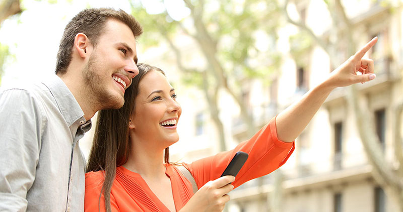 Couple pointing to apartment